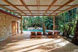 an outdoor patio with chairs and a swimming pool at Havana Lodge in Mal País