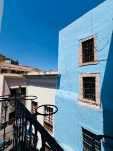 a blue and white building with barred windows at Mansion Von Humboldt in Guanajuato