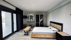 a bedroom with a bed and a table and a mirror at Silia Villas in Ormos Panagias +36 photos
