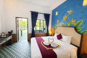 a hotel room with a bed with a rooster on it at Minh Chau Beach Resort in Quang Ninh +134 photos