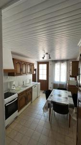 a kitchen with a table and a dining room at Domaine du Mont des Chênes in Monthou-sur-Cher