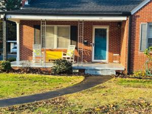 a house with two chairs on the front porch at Retro Retreat in Wilson