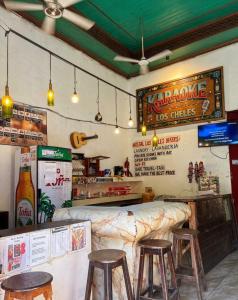 a restaurant with a bar with stools in it at Hostal los Cheles in León