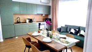 a kitchen with a table and chairs and a kitchen with a table and a table at La felix bulevard in Biharia