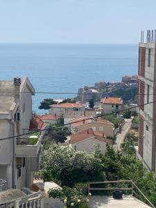 a view of a city with the ocean in the background at New Apartments Blue in Ulcinj