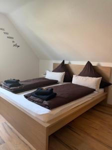 a bedroom with two beds with brown comforters at Haus87a in Oberkirch