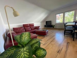a living room with a red couch and a table at Haus87a in Oberkirch