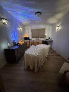 a room with a bed and a table with blue lights at The Cabins at Riptide Resort in Seward