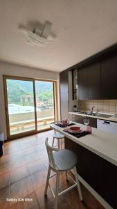 a kitchen with a counter with a chair and a table at Casa Luisa in Recco