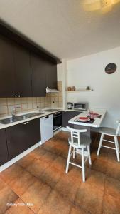a kitchen with a table and two chairs in it at Casa Luisa in Recco