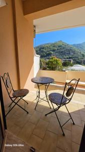 two chairs and a table on a balcony with a view at Casa Luisa in Recco +7 photos