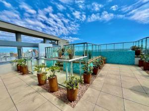 a balcony with potted plants on top of a building at Town Co - Apartment 1004 in Porto Alegre