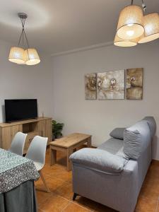 a living room with a couch and a table at Alfarnate Antiguo Cuartel in Alfarnate
