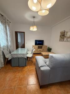 a living room with a table and a couch at Alfarnate Antiguo Cuartel in Alfarnate +4 photos