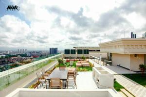 a balcony with tables and chairs on a building at BRG Luxury Apartments in Hai Phong