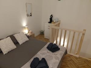 a bedroom with a bed with two pillows on it at Duplex with Jacuzzi - Grand place Arras in Arras