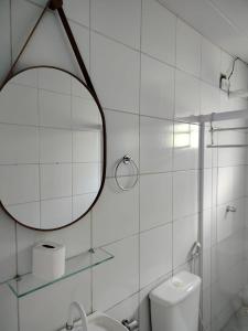 a bathroom with a mirror and a toilet and a sink at Casa Noronha tropical 2 in Fernando de Noronha