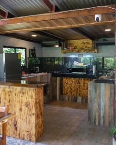 a large kitchen with wooden counter tops and wooden floors at Kibutz Eco Guesthouse in Fortuna