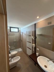 a bathroom with two sinks and a shower at HOTEL TRIESTE in Riccione +47 photos
