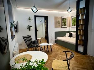 a living room with a bed and a table and chairs at Apartamenty Młyńska 3A in Gliwice