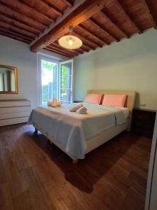 a bedroom with a bed and a large window at Tipical Tuscany Apartment near Lucca! in Capannori