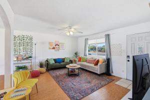 a living room with a couch and a table at Tempe Resort, Pool with Diving Board, 4BR in Tempe