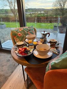 a table with breakfast food on it with a window at Heron's Rest Studio in Macroom