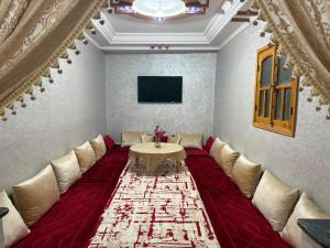 a living room with a table and a couch at 5 Min to Beach & Calm Villa Retreat in Safi