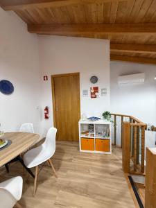 a room with a table and chairs and a wooden door at Casa das Flores in Sardoal +7 photos