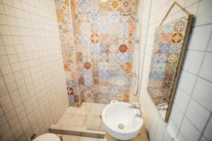 a bathroom with a shower with a sink and a toilet at Green Sheep Boutique Hotel in Kazbegi