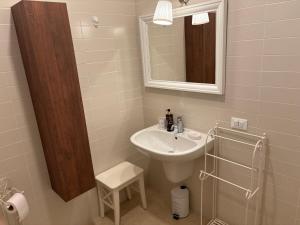 a bathroom with a sink and a mirror at Appartamento Verde Golf in Miglianico +24 photos
