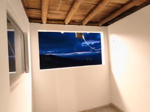 a picture on the wall of a room with a window at Hospedaje Finca Eje Cafetero, Casa Ne u in Marsella +29 photos