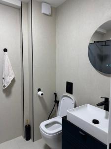 a bathroom with a toilet and a sink and a mirror at Dolce dimora in Bar +40 photos
