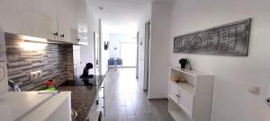 a kitchen with white walls and a long hallway at Benal Beach Vibe in Benalmádena