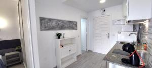 a kitchen with a counter and a white refrigerator at Benal Beach Vibe in Benalmádena +42 photos