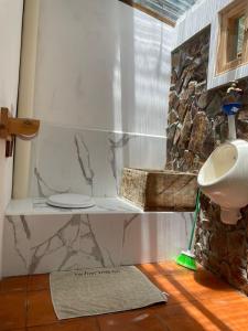 a bathroom with a sink and a toilet in a room at The Black Sheep Inn in Chugchilán +97 photos