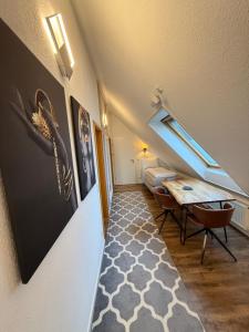 a attic room with a table and a bed at CityApartments Residence klimatisiert in Friedrichshafen
