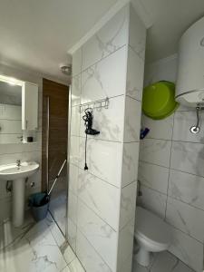 a bathroom with a shower and a toilet and a sink at Duo Apartments in Bar +33 photos