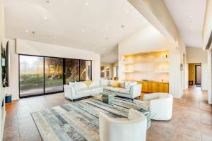 a living room with white furniture and a large window at Seaspray in Sea Ranch