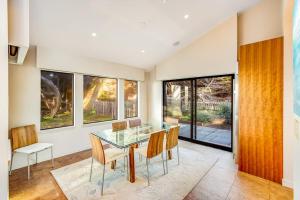 a dining room with a glass table and chairs at Seaspray in Sea Ranch