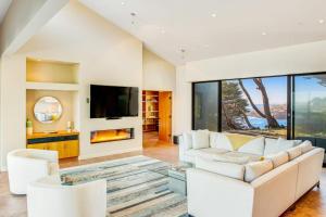 a living room with a couch and a fireplace at Seaspray in Sea Ranch