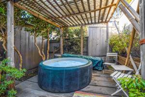a hot tub sitting on a patio with a pergola at Eurella in Annapolis