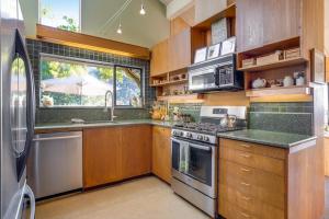 a kitchen with wooden cabinets and a stove top oven at Eurella in Annapolis