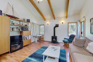 a living room with a couch and a fireplace at Loon's Landing in Sea Ranch