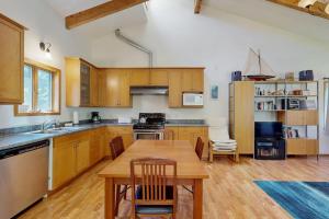 a kitchen with wooden cabinets and a wooden table at Loon's Landing in Sea Ranch +6 photos