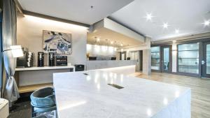 a kitchen with a large white table in a room at Sandman Hotel & Suites Kelowna in Kelowna