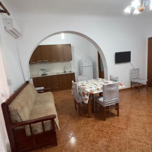 a living room with a table and a couch at Orikum Holiday Apartaments in Orikum