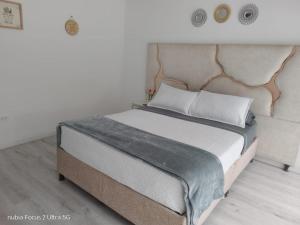 a bedroom with a large bed with a headboard at Room cerca al aeropuerto #1 in Bogotá +19 photos