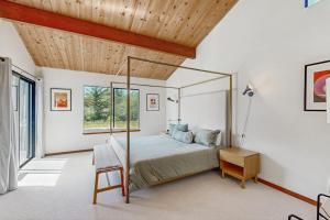 a bedroom with a bed and a wooden ceiling at Hilma House in Sea Ranch