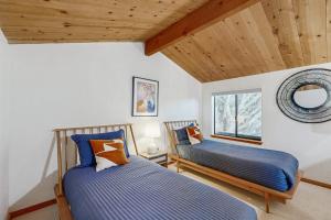 a bedroom with two beds and a window at Hilma House in Sea Ranch